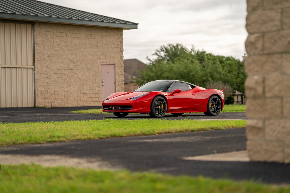 Red 2015 Ferrari 458 Italia with black rims and yellow brake calipers.