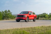 Red 2022 Ford F-150 Roush on rugged rims, with custom black trim and livery.