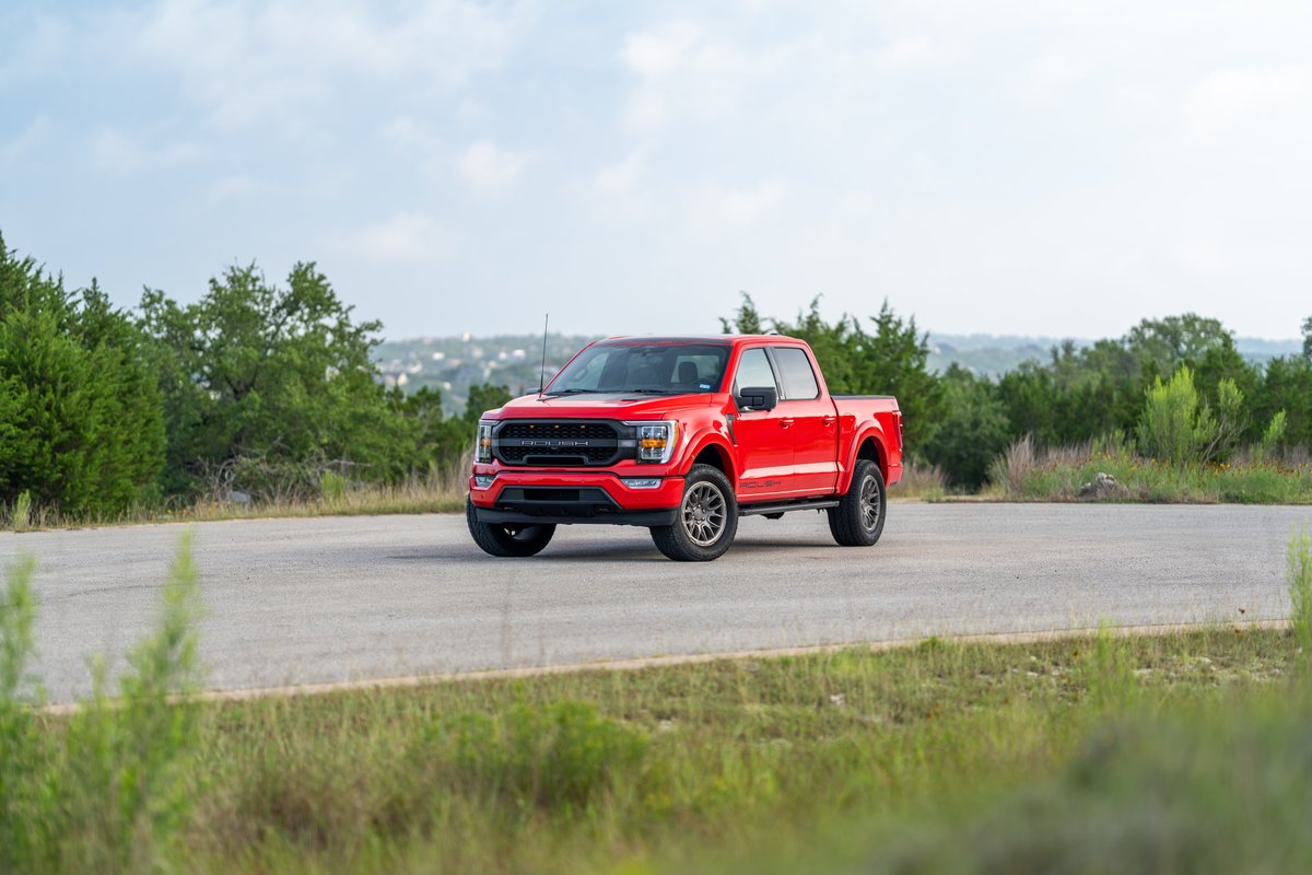 Red 2022 Ford F-150 Roush with aggressive front trim and dark rims.