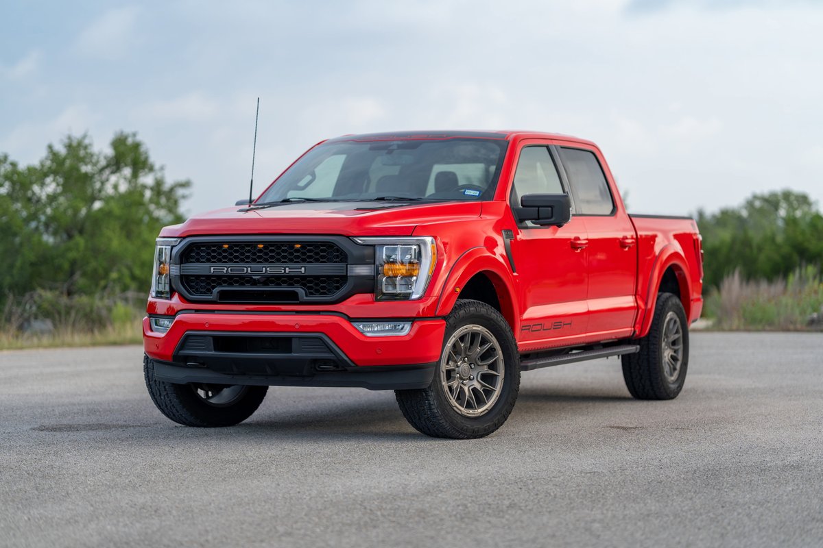 Red 2022 Ford F-150 Roush pickup truck with black grille, aggressive front bumper, and custom rims.