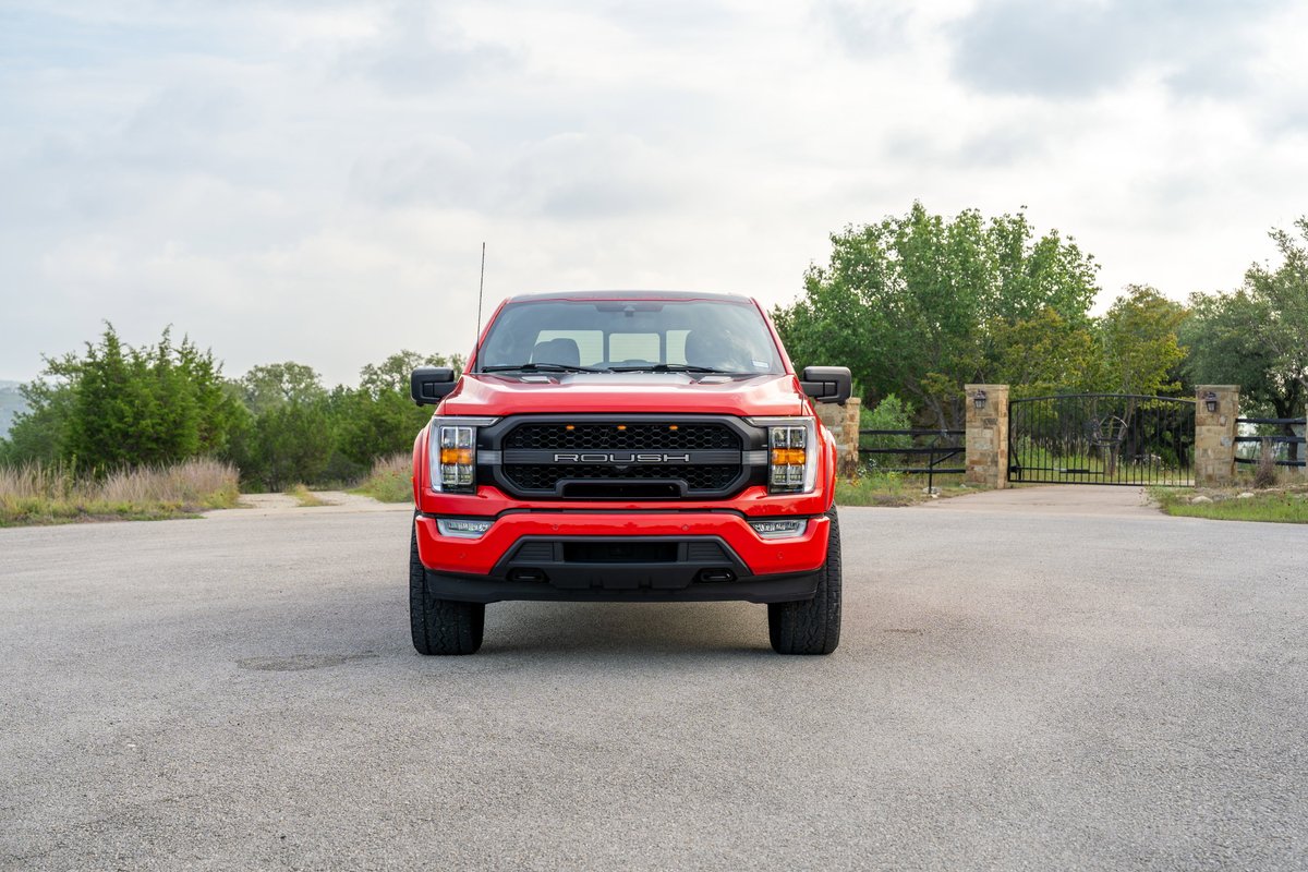 Front view of a red 2022 Ford F-150 Roush with black grille trim.
