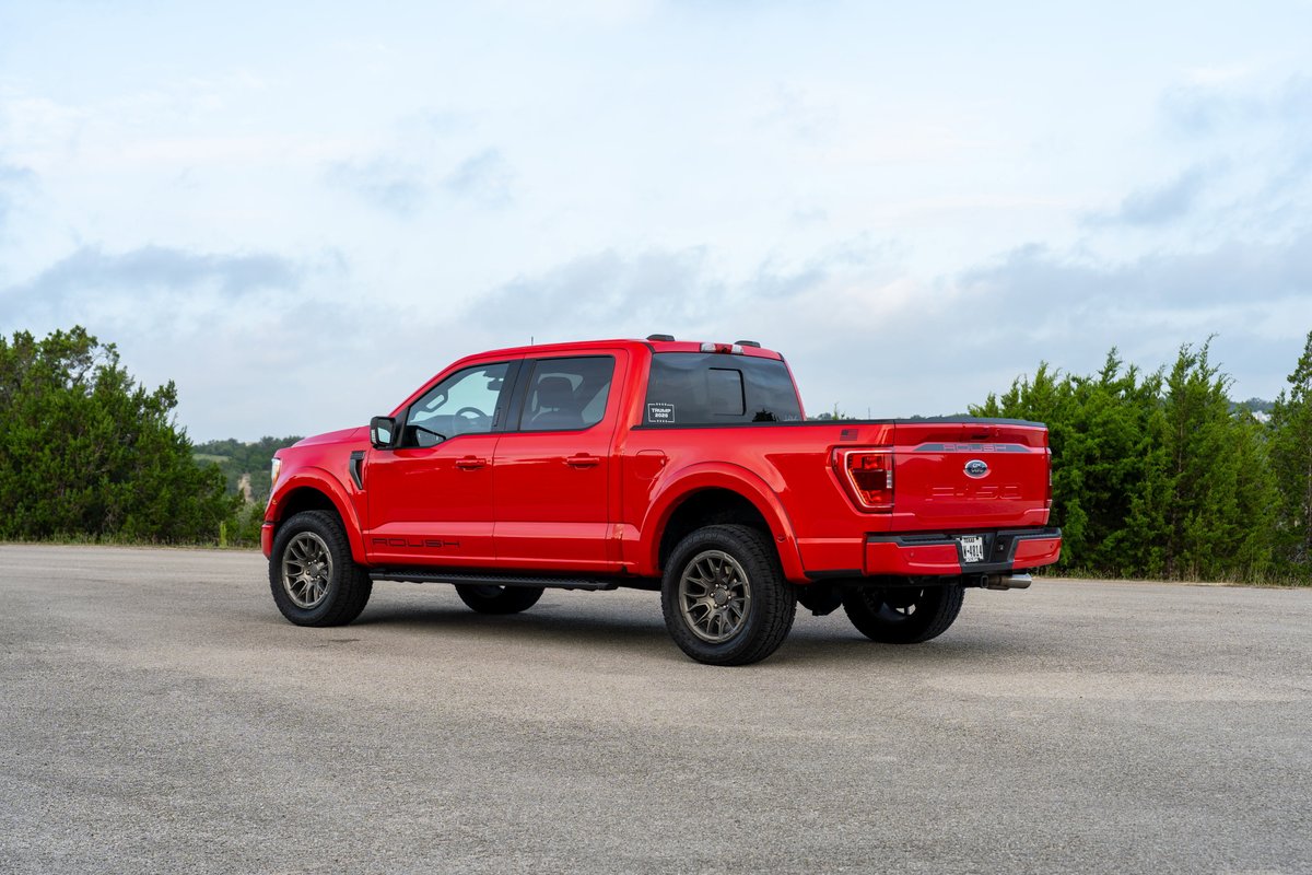 Red 2022 Ford F-150 Roush with dark grey rims and black accents on the rear spoiler.