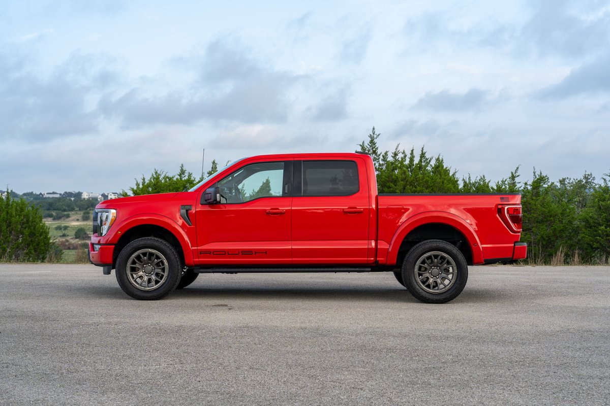 Red 2022 Ford F-150 Roush with dark grey rims parked on asphalt.