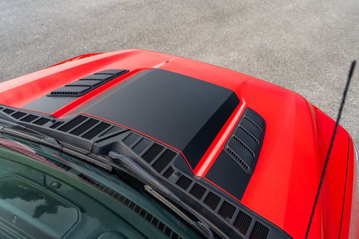 Red 2022 Ford F-150 Roush hood with black accent trim and vents.
