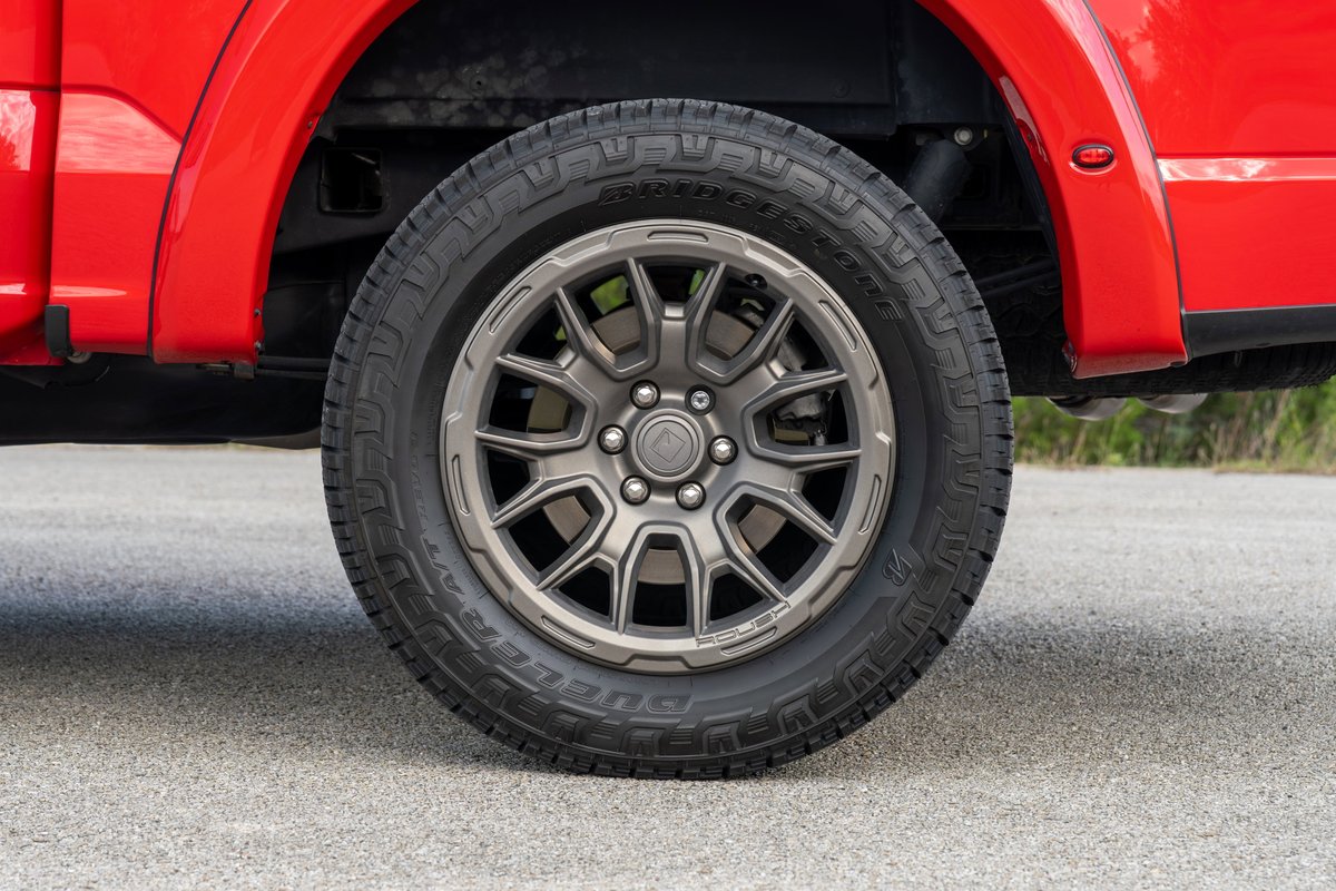 Red 2022 Ford F-150 Roush with aftermarket gray alloy rims and all-terrain tires.