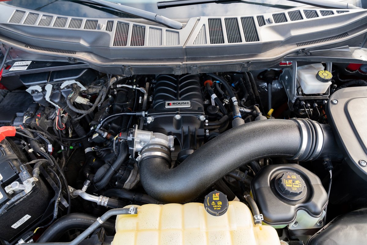 Red 2022 Ford F-150 Roush engine bay with supercharger.