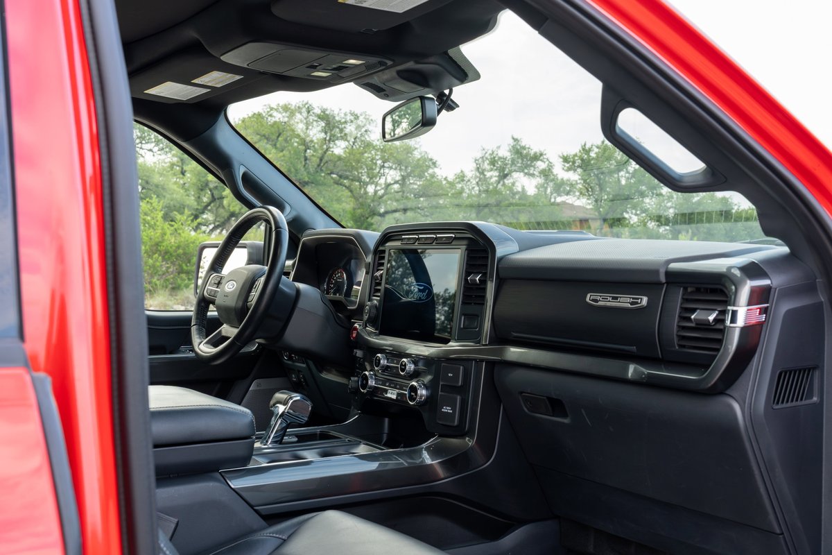 2022 Red Ford F-150 Roush interior with large touchscreen and dark trim.