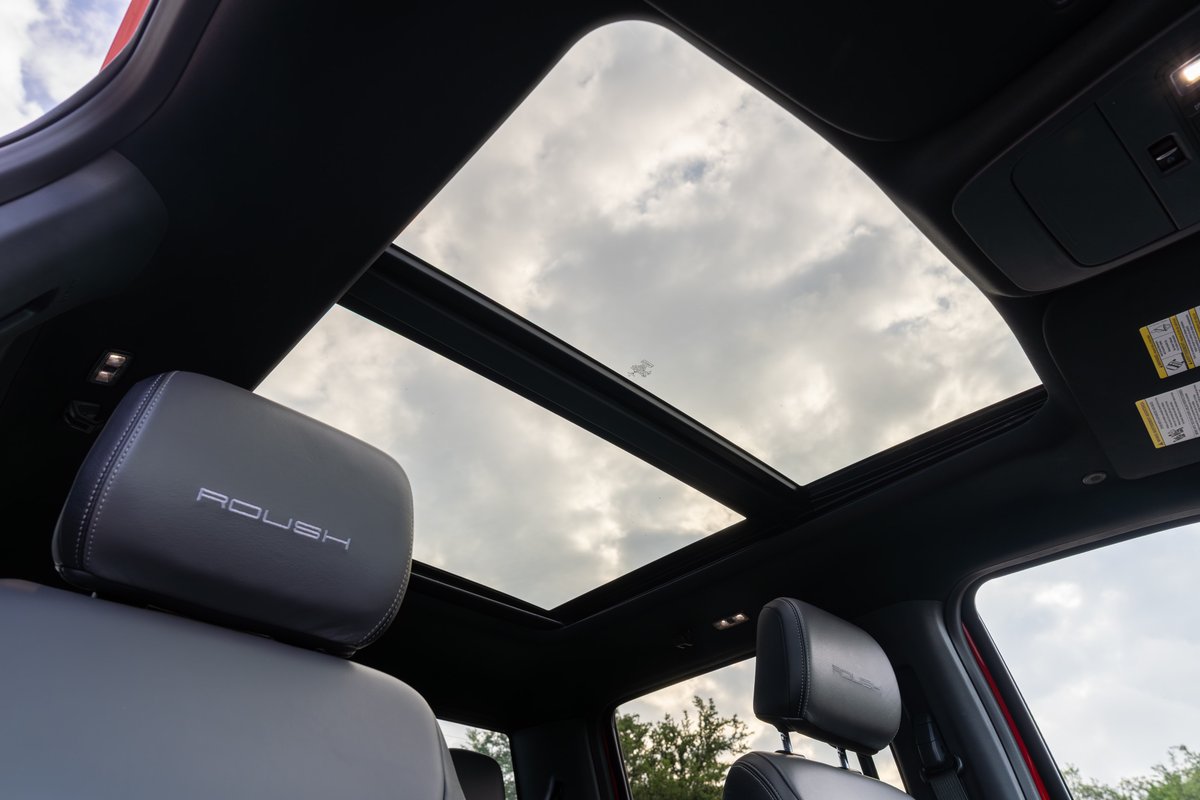 2022 red Ford F-150 Roush with panoramic sunroof and embossed headrests.