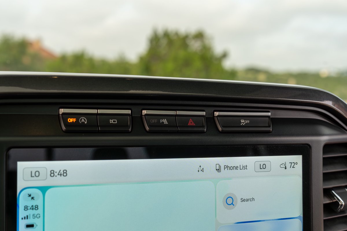 Red 2022 Ford F-150 Roush interior: dashboard buttons for lane assist, parking sensors, and trailer backup assist.