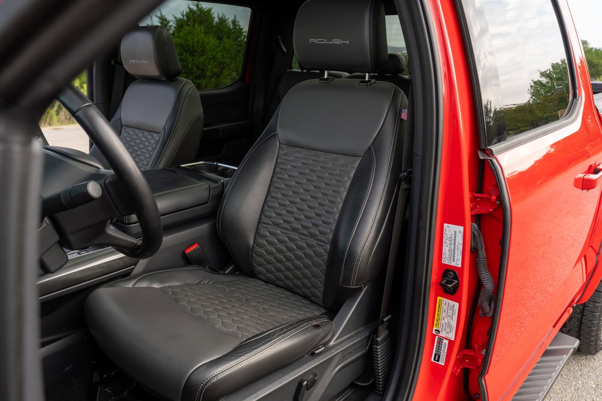 2022 Red Ford F-150 Roush interior. Black leather seats with textured inserts and "Roush" headrest badging.