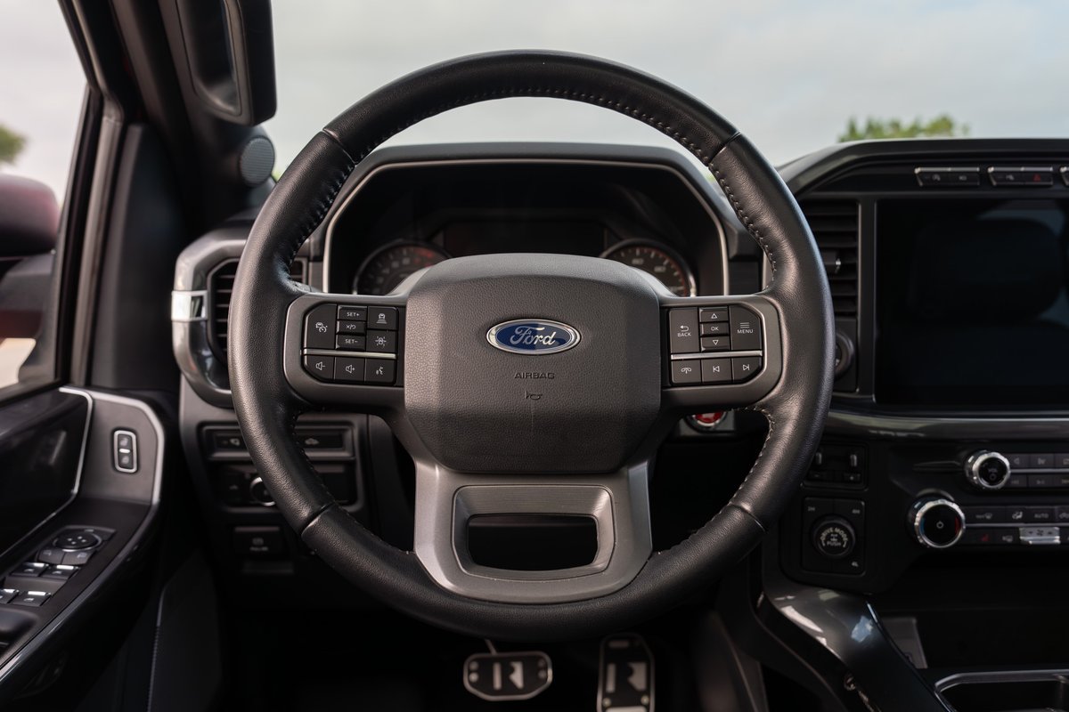 2022 Ford F-150 Roush steering wheel and dashboard with a large touchscreen and digital instrument cluster.