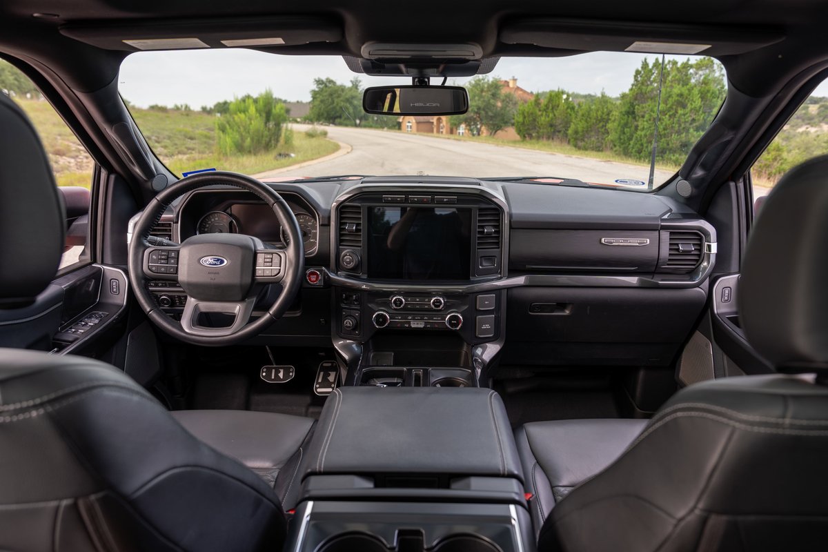 Interior of a red 2022 Ford F-150 Roush showing dashboard, steering wheel, and seats.