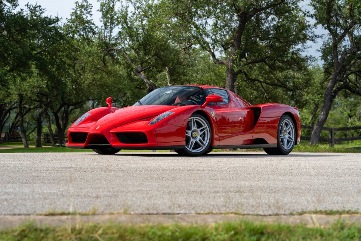 Rosso Corsa 2003 Ferrari Enzo with silver five-spoke rims.