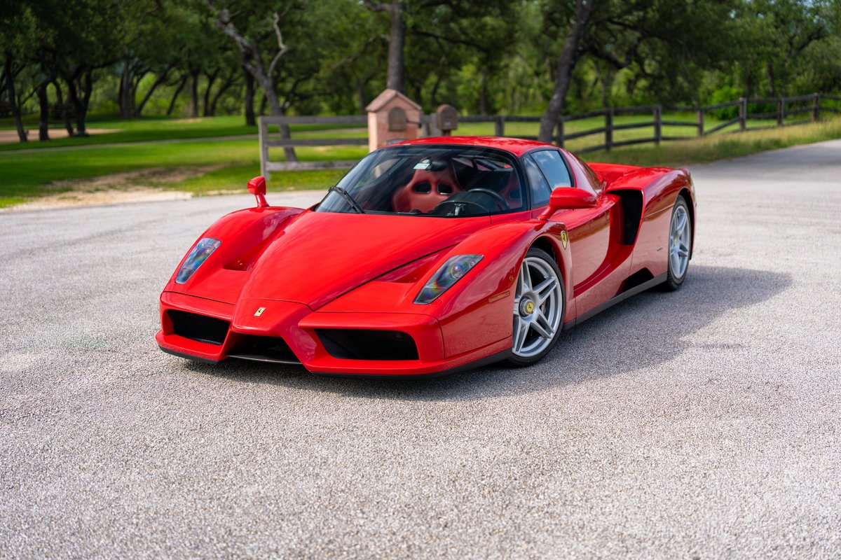 Rosso Corsa 2003 Ferrari Enzo with silver rims and black trim details.