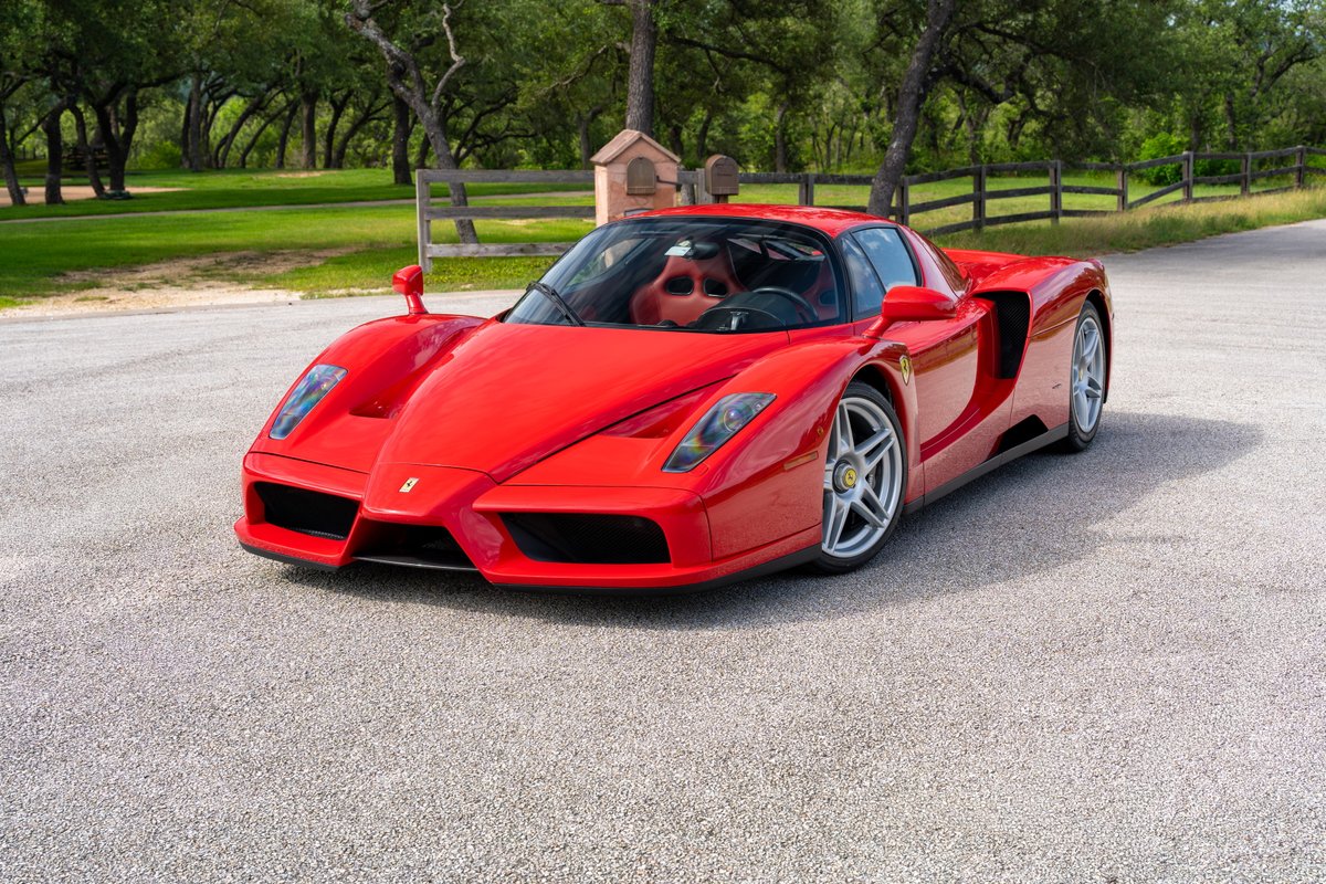 Rosso Corsa 2003 Ferrari Enzo with silver rims and black trim.