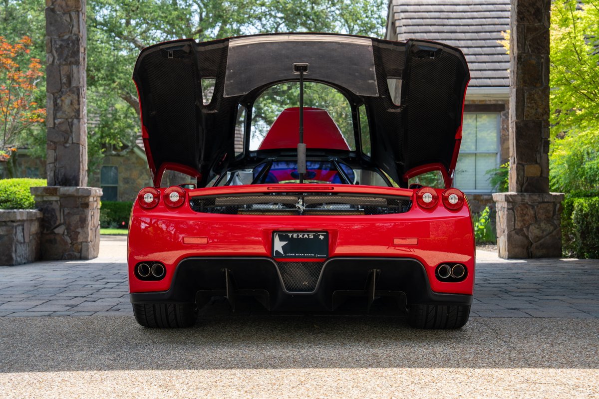Rear view of a Rosso Corsa 2003 Ferrari Enzo with doors open.