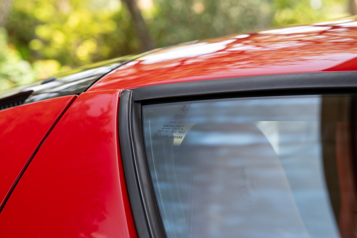 Close-up of a red Ferrari Enzo's glass trim and roofline.