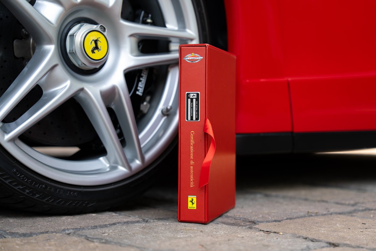 Rosso Corsa Ferrari Enzo detail: silver alloy wheel, caliper, and red binder.