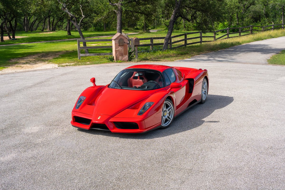 Rosso Corsa 2003 Ferrari Enzo with silver five-spoke rims.
