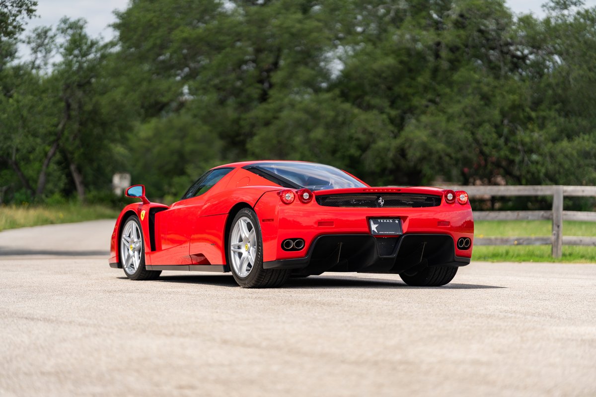 Rosso Corsa Ferrari Enzo with silver rims and black trim.