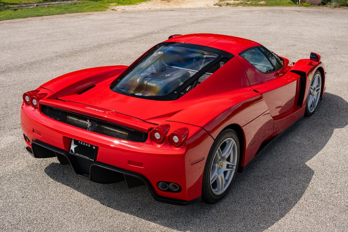 Rosso Corsa 2003 Ferrari Enzo with silver rims.