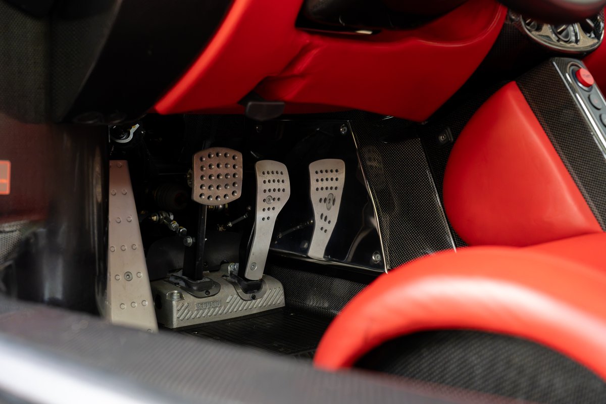 Rosso Corsa Ferrari Enzo pedals with carbon fiber trim and red leather interior.