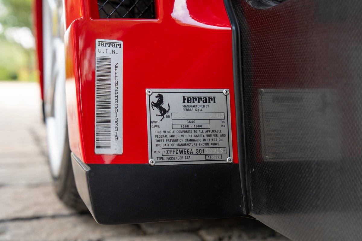 Close-up of red 2003 Ferrari Enzo VIN plate, showing VIN ZFFCWS6A301.