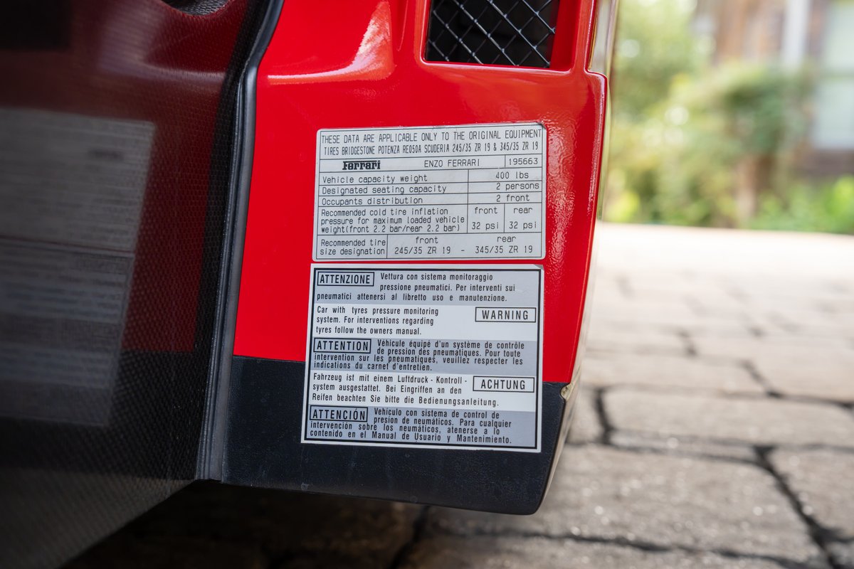 Red 2003 Ferrari Enzo tire pressure placard with 20-inch wheels.