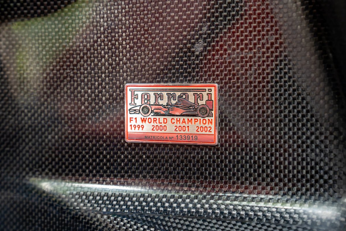 Ferrari Enzo carbon fiber interior with F1 World Champion badge.