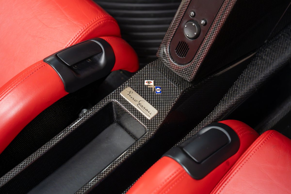 Rosso Corsa Ferrari Enzo interior with carbon fiber trim and red leather seats.