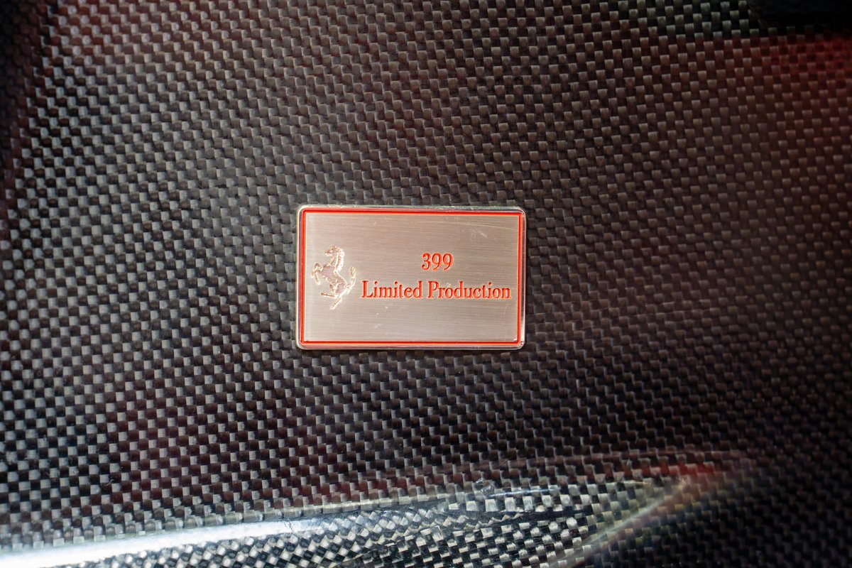 Ferrari Enzo limited production badge on carbon fiber trim.