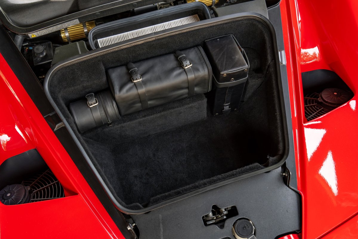 Red 2003 Ferrari Enzo front trunk with leather luggage.