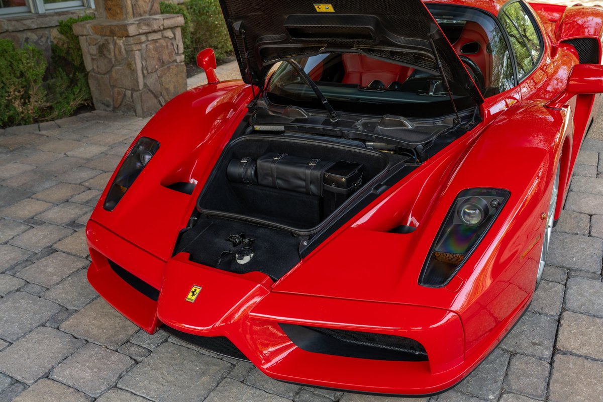 Rosso Corsa 2003 Ferrari Enzo front with hood open, showing interior and trunk.