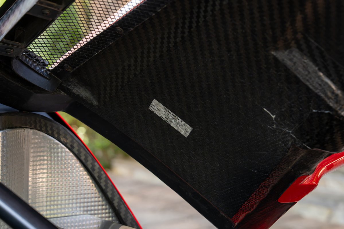 Red 2003 Ferrari Enzo with carbon fiber interior trim and mesh grille.