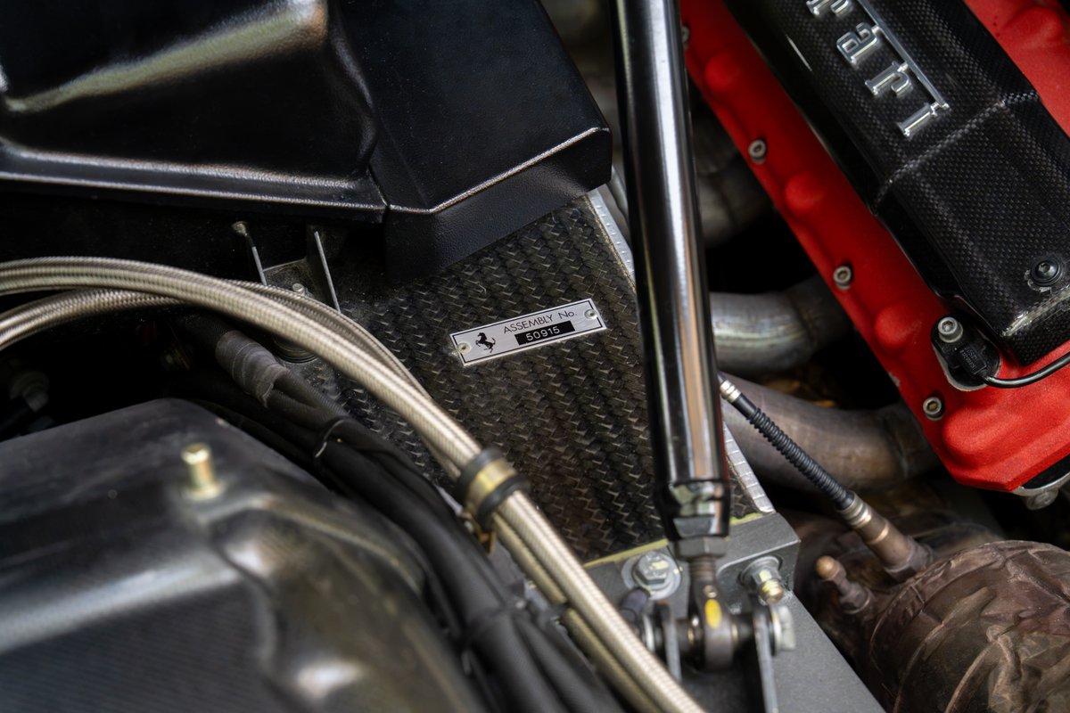 Close-up of a Ferrari Enzo's carbon fiber weave and assembly plate.
