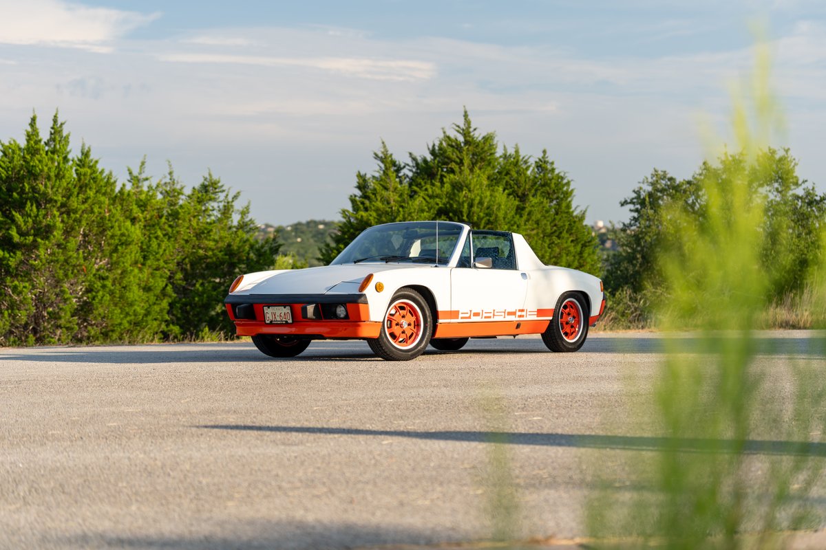 1974 Porsche 914 Can-Am LE with orange trim and rims, white body.