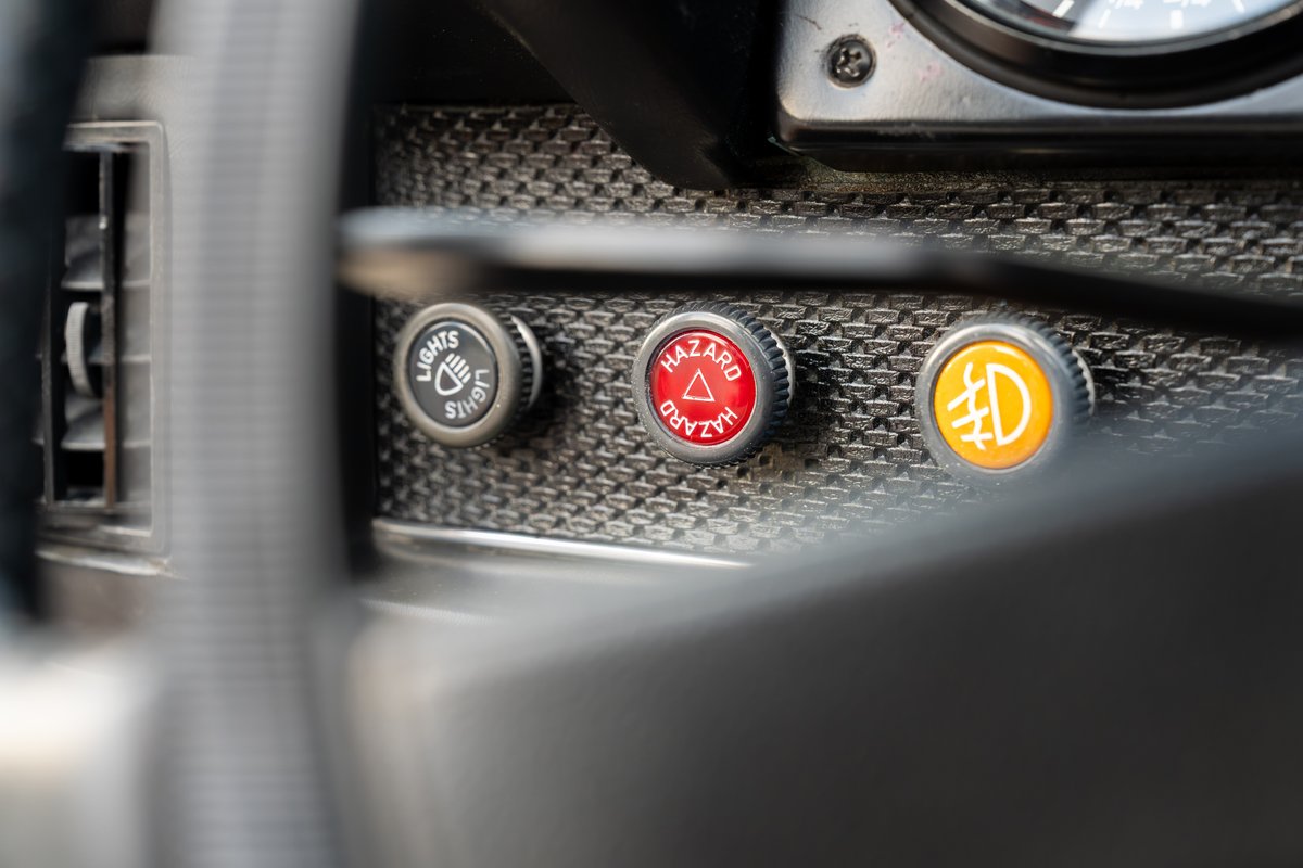 Classic Porsche 914 dashboard with lights, hazard, and fog light buttons.