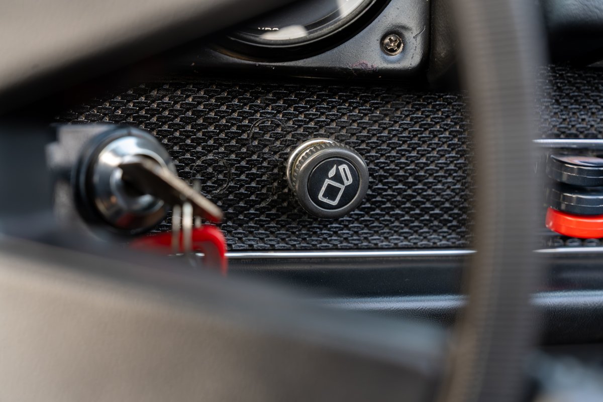 1974 Porsche 914 interior detail: ignition key and ashtray button.