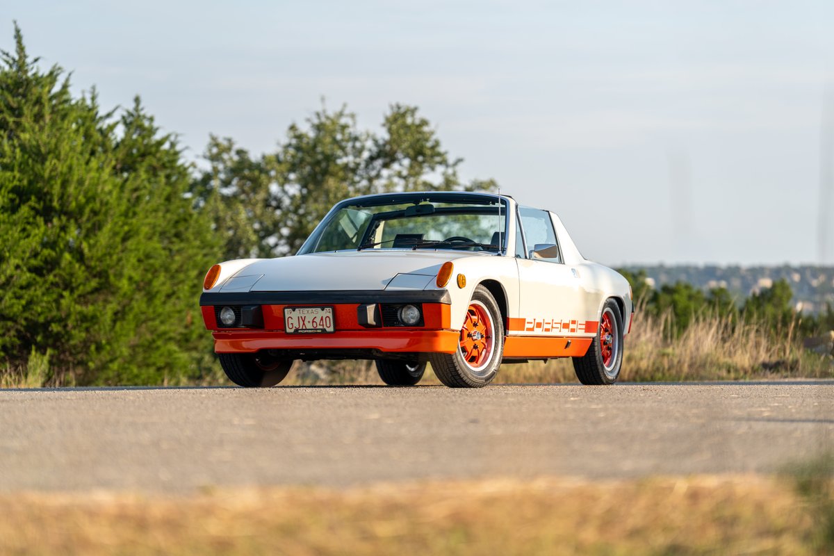 1974 Porsche 914 Can-Am with orange trim and livery, white paint, on orange rims.