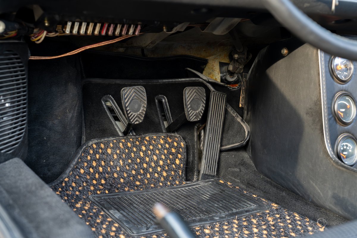 1974 Porsche 914 Can-Am pedals and dashboard with aftermarket floor mats.