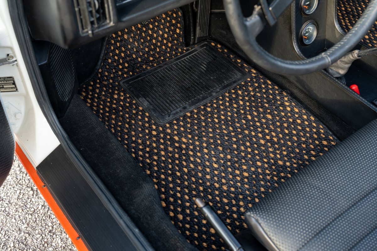 Interior shot of a 1974 Porsche 914 Can-Am LE with custom black and tan floor mats.