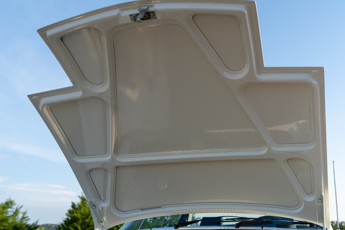 The underside of the white hood of a 1974 Porsche 914 Can-Am LE.