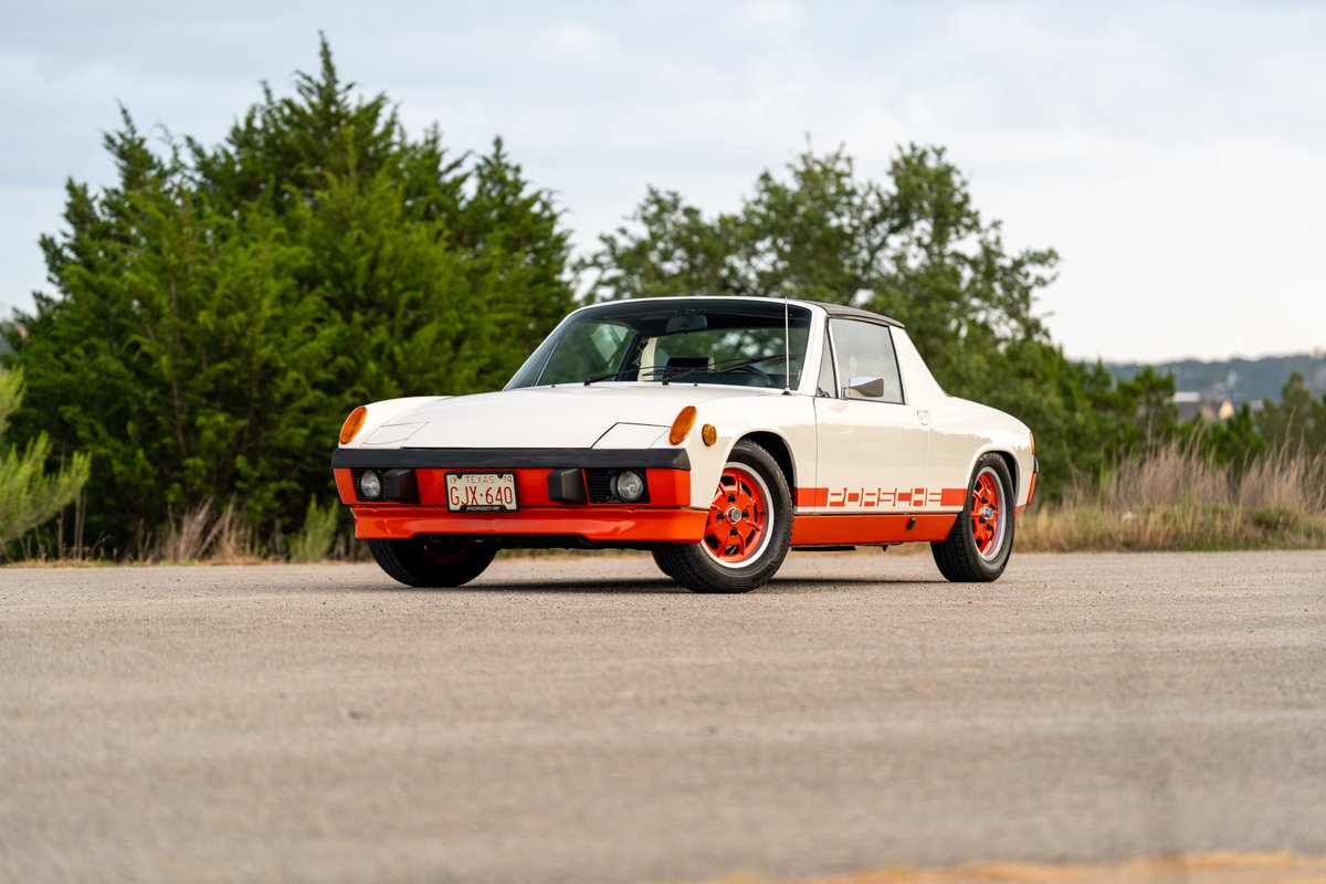 1974 Porsche 914 Can-Am LE in white with orange trim and "PORSCHE" livery, on orange rims.