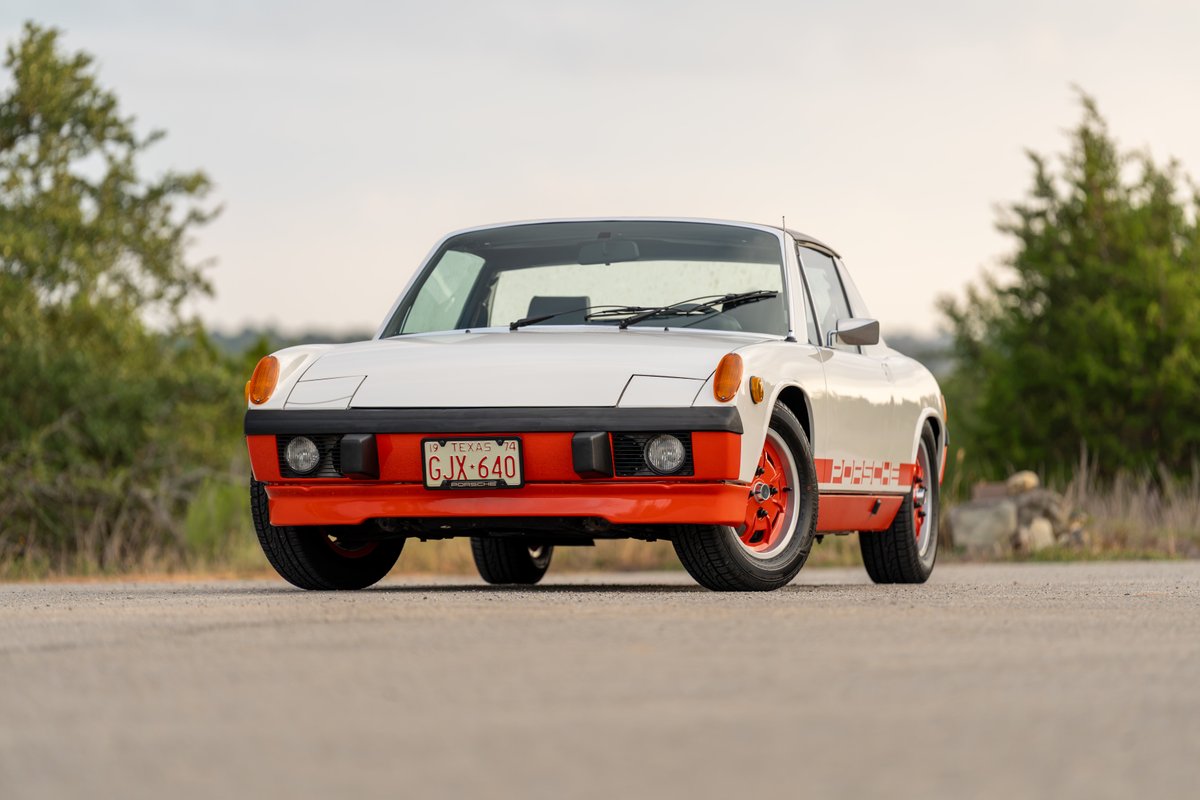 1974 Porsche 914 Can-Am Edition in creamsicle orange and white with custom livery and rims.