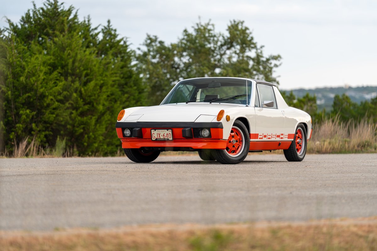 White 1974 Porsche 914 Can-Am with orange trim, livery, and rims.