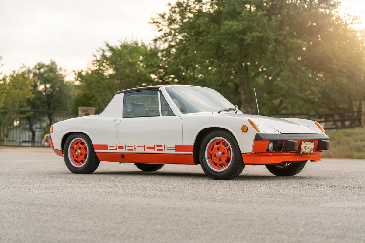 White 1974 Porsche 914 Can-Am Edition with orange trim, livery, and rims.