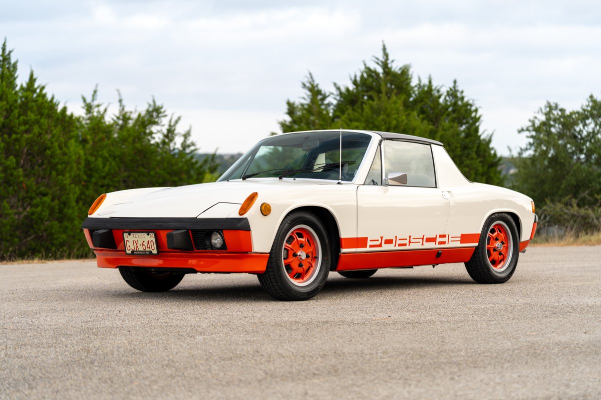 White 1974 Porsche 914 with orange trim, Porsche livery, and orange rims.