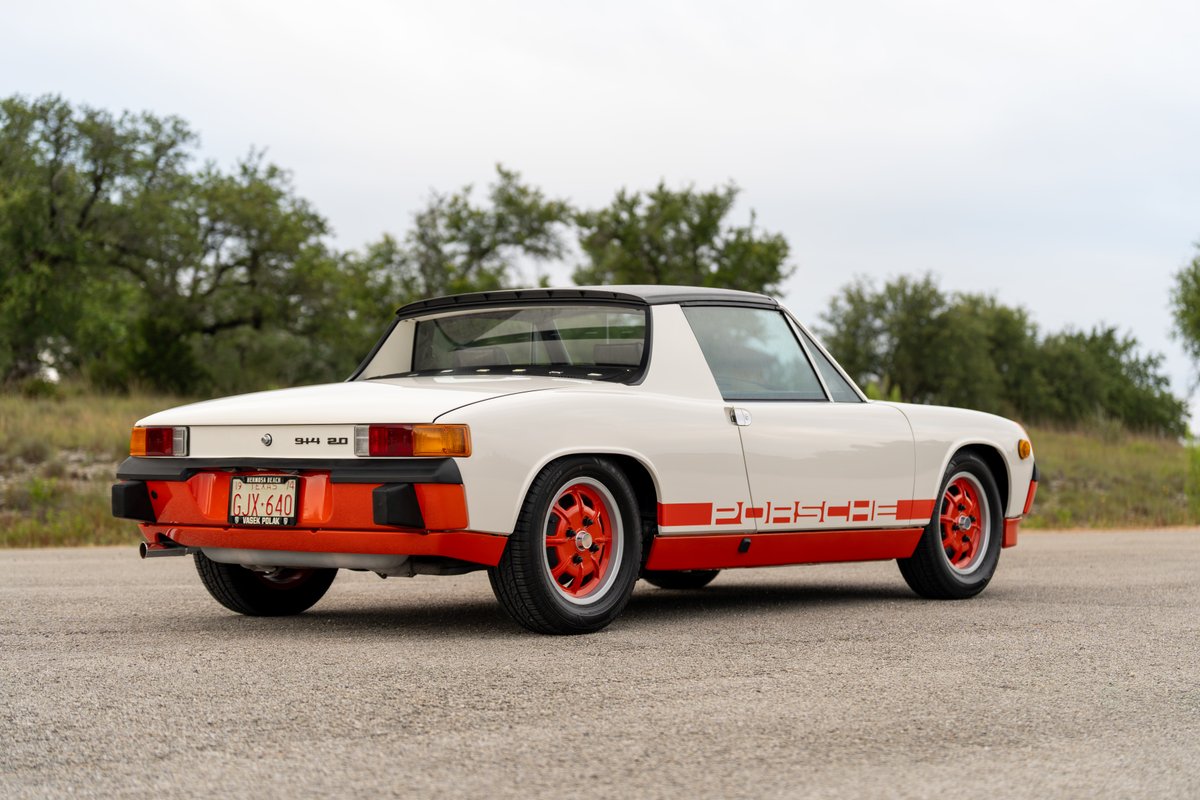 White 1974 Porsche 914 Can-Am LE with orange racing stripes, trim, and rims.