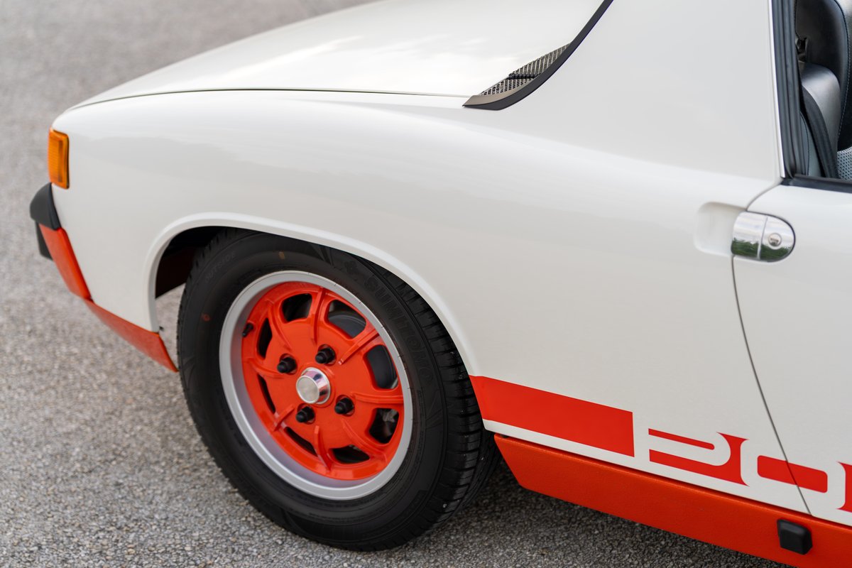 1974 Porsche 914 Can-Am with orange trim and silver rims.