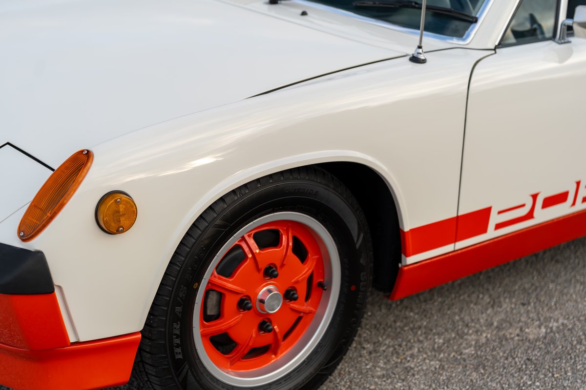 1974 Porsche 914 Can-Am with orange rims, red trim, and side livery.
